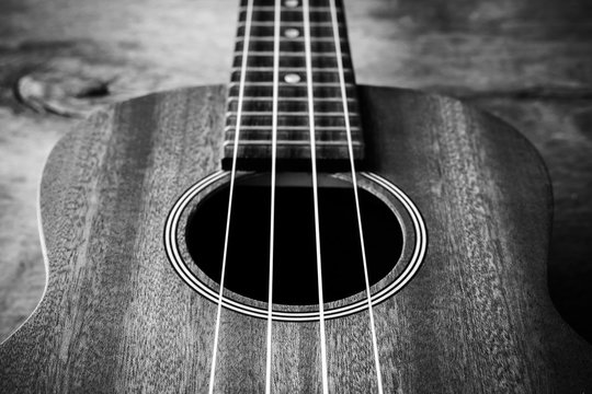 Close up of ukulele on old wood background