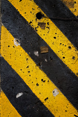 Fototapeta premium Old black and yellow danger strips line background.