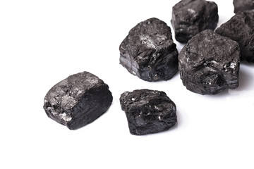 Loose lumps of black coal on white background