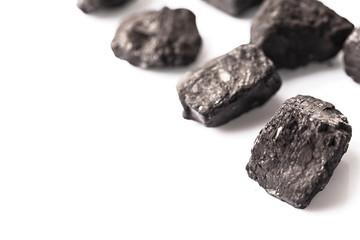 Loose lumps of black coal on white background