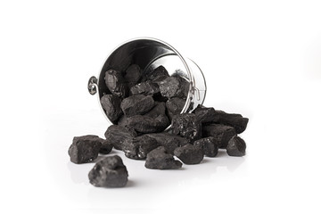 Silver bucket with lumps of black coal on a white background