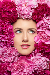 Beautiful girl with pink peony flowers