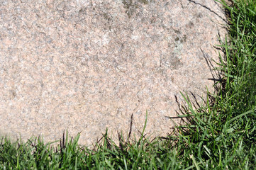 Textured background natural stone frame with grass