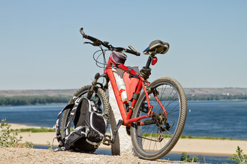 Fototapeta na wymiar Mountain Bike stay on the background of river scenery