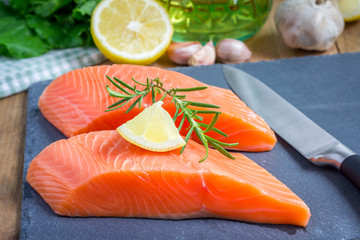 Fresh raw salmon fillet with rosemary and lemon