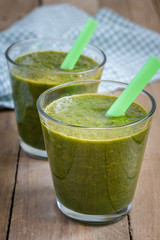 Healthy green spinach carrot smoothie in a glass