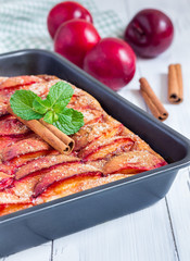 Homemade plum pie in a baking dish