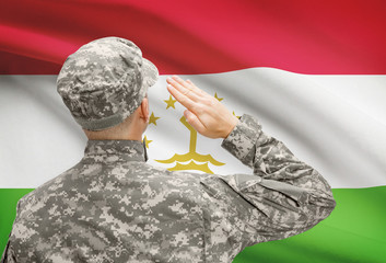 Soldier in hat facing national flag series - Tajikistan