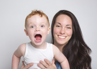 baby boy with his mother over a isolated white background