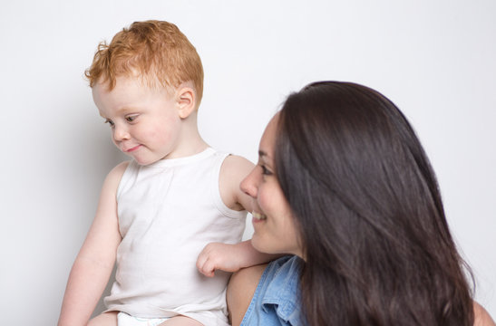 baby boy with his mother over a isolated white background