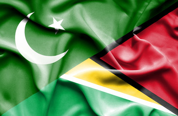 Waving flag of Guyana and Pakistan