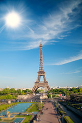 Fototapeta na wymiar summer day the sun shines over the Eiffel Tower symbol of Paris.