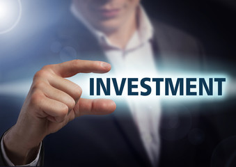 Businessman presses button investment on virtual screens. Busine