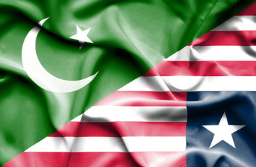 Waving flag of Liberia and Pakistan