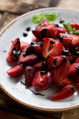 Sliced strawberries poured with chocolate, selective focus