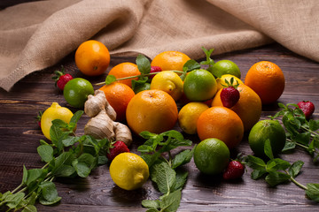 Various fruits scattered on a wooden background.
