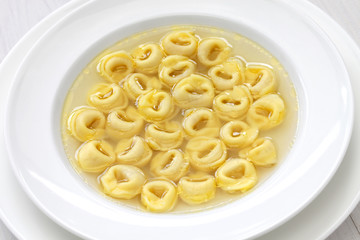 tortellini in brodo, ring shaped pasta in broth, italian cuisine