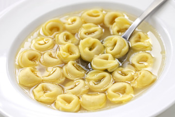 tortellini in brodo, ring shaped pasta in broth, italian cuisine