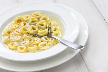 tortellini in brodo, ring shaped pasta in broth, italian cuisine