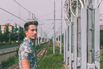 Young handsome man posing in a metro station