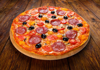 Delicious pizza with salami, mushrooms and olives