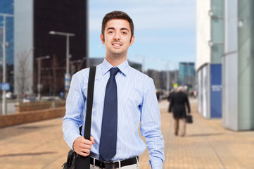 Young businessman walking on the street