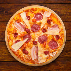Delicious italian pizza with salami, bacon and parmesan