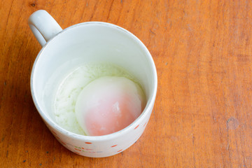 Chinese style breakfast, soft boiled egg in glass