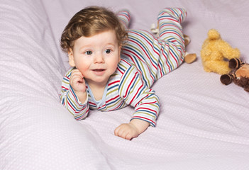 Beautiful baby with a lovely toys.The child in the crib
