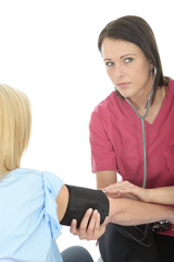 Young Female Doctor Taking The Blood Pressure Of A Female Patient