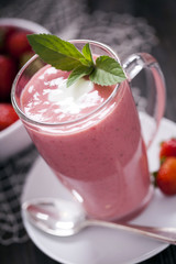 Delicious dessert protein with strawberries. Yogurt in a glass