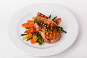 beautiful steak grilled cage with vegetables on a plate white
