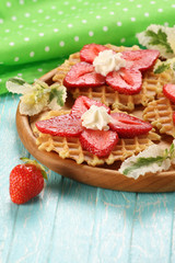 Strawberry dessert with cream on a wooden platter