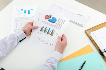 Businessman checking financial graphs