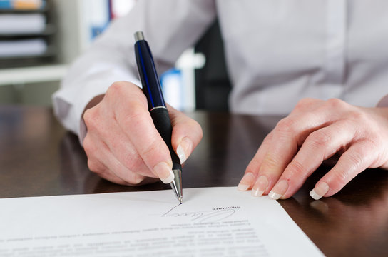 Businesswoman signing a document