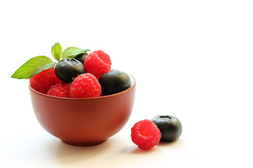 Blueberries and raspberries on a white background