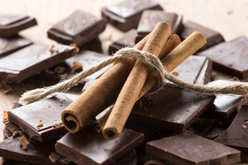 Chocolate with cinnamon sticks, selective focus