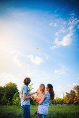 Family playing with a kite outdoor