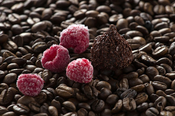 Chocolate with raspberries on coffee background, selective focus