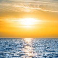 Fototapeta na wymiar Sunset above the blue sea