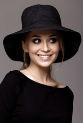 Portrait of a beautiful woman in black hat. Portrait isolated