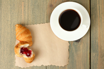 Fresh croissants on paper with cofee