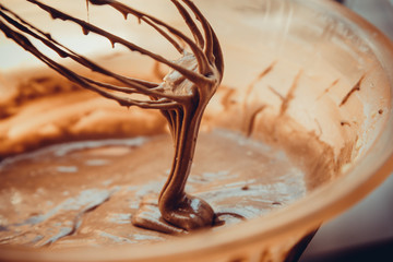 chocolate dough on wire whisk
