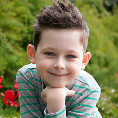 Stylish baby boy with dark hair in  striped polo-neck. Smile. Hi © tkovbasovska