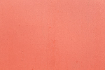 A grained red concrete wall with texture, some spots but they are there to make it more real