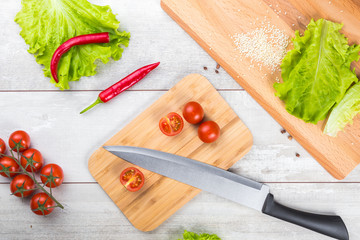 Tomato, toasts, meat and salad on wooden table