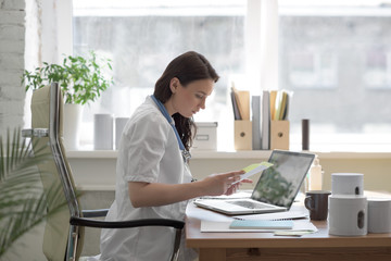 Doctor working with test results and computer