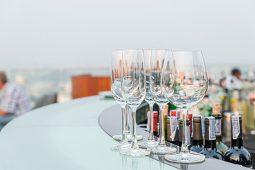 Many empty glass on counter at rooftop bar