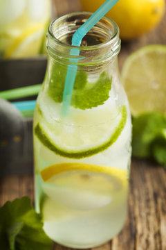 Close up Lemonade in glass bottle with ice and mint