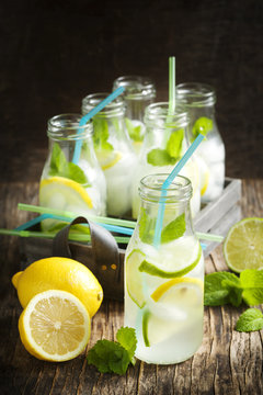 Lemonade in glass bottle with ice and mint